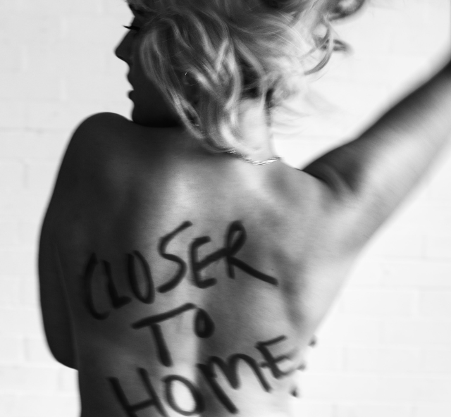 Black and white photo of singer Kala Gare's back with the words Closer to Home written on it