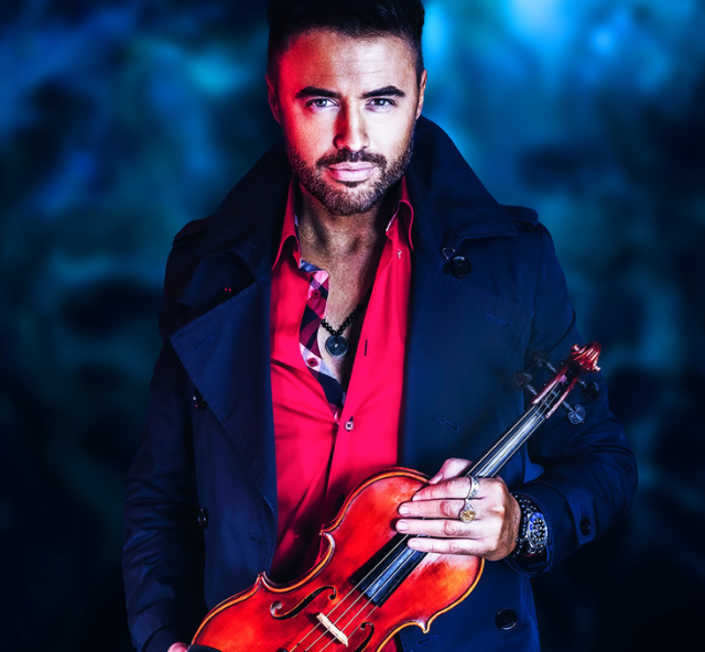 Photo of the artist Patrick Roberts holding his violin