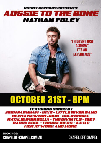 Singer Nathan Foley siting and holding a guitar across his lap