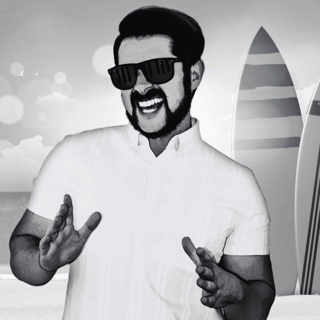Person in a white t-shirt on the beach in front of two surf boards