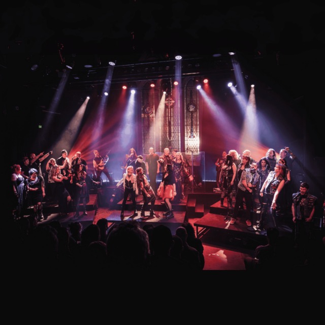 Members of Heavy Choir & Live Band performing onstage under spot lights