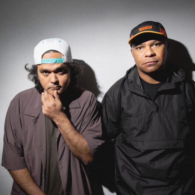 The artists Birdz and Fred Leone standing side by side with baseball hats on