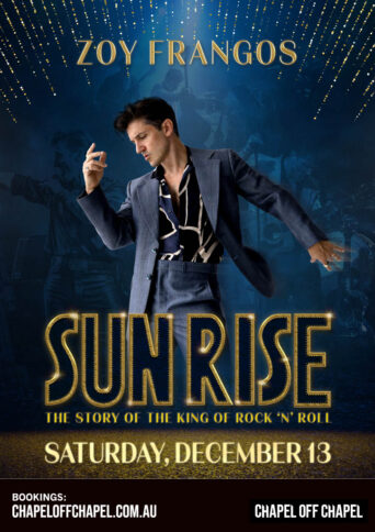 Performer Zoy Frangos in a blue suit posing as Elvis