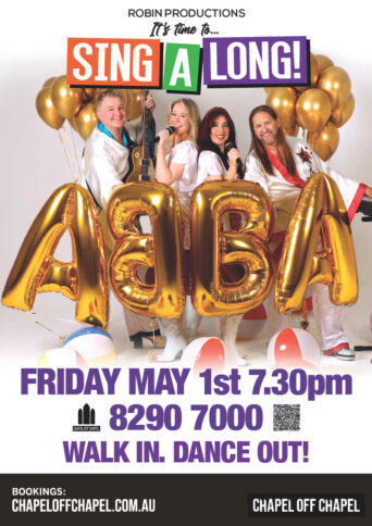 Four performers dressed like ABBA with large gold balloons