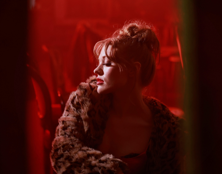 Performer from Sweet Charity on side profile with fur coat