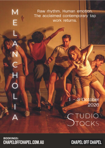 A group of tap dancers holding a pose in a room with a warm glow