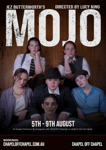 Five females dressed as gangsters leaning over each others shoulders